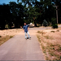 Steve Reynolds posing in front of property