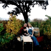 Steve, Suzie and Cameron Reynolds sitting on tractor in the vineyards