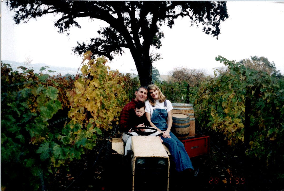 Steve, Suzie and Cameron Reynolds sitting on tractor in the vineyards
