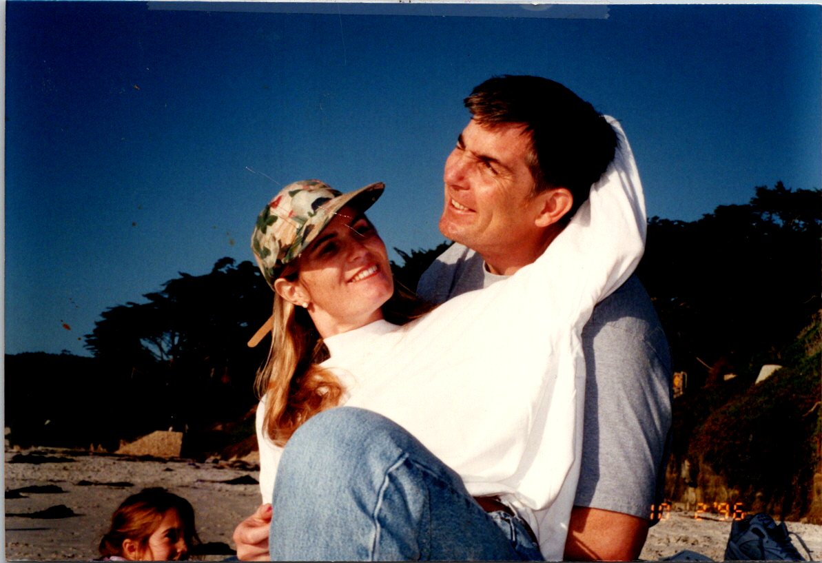 steve and suzie reynolds hugging on the beach in the early days